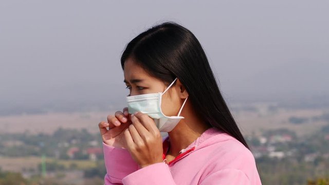 Asian women wearing dust mask and headache protect from wuhan coronavirus china health emergency.