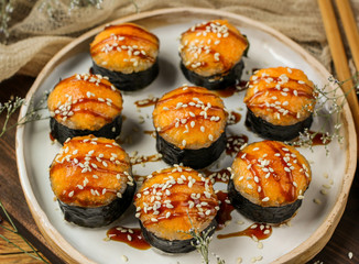 Sushi with a cheese cap