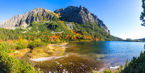 Panoramic picturesque view of mountain glacier lake Poprad (Slovak: Popradske pleso) in High Tatras, Slovakia. Sunny autumn day