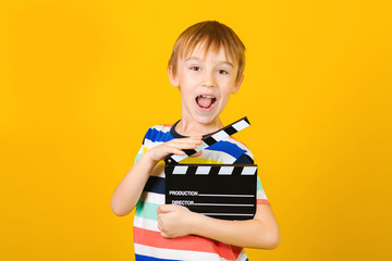 Kid hands holding clapper board for making video cinema in studio. Movie production clapper board...