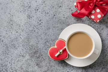 Valentines day greeting card with heart cookies, love letter, coffee cup on grey table.