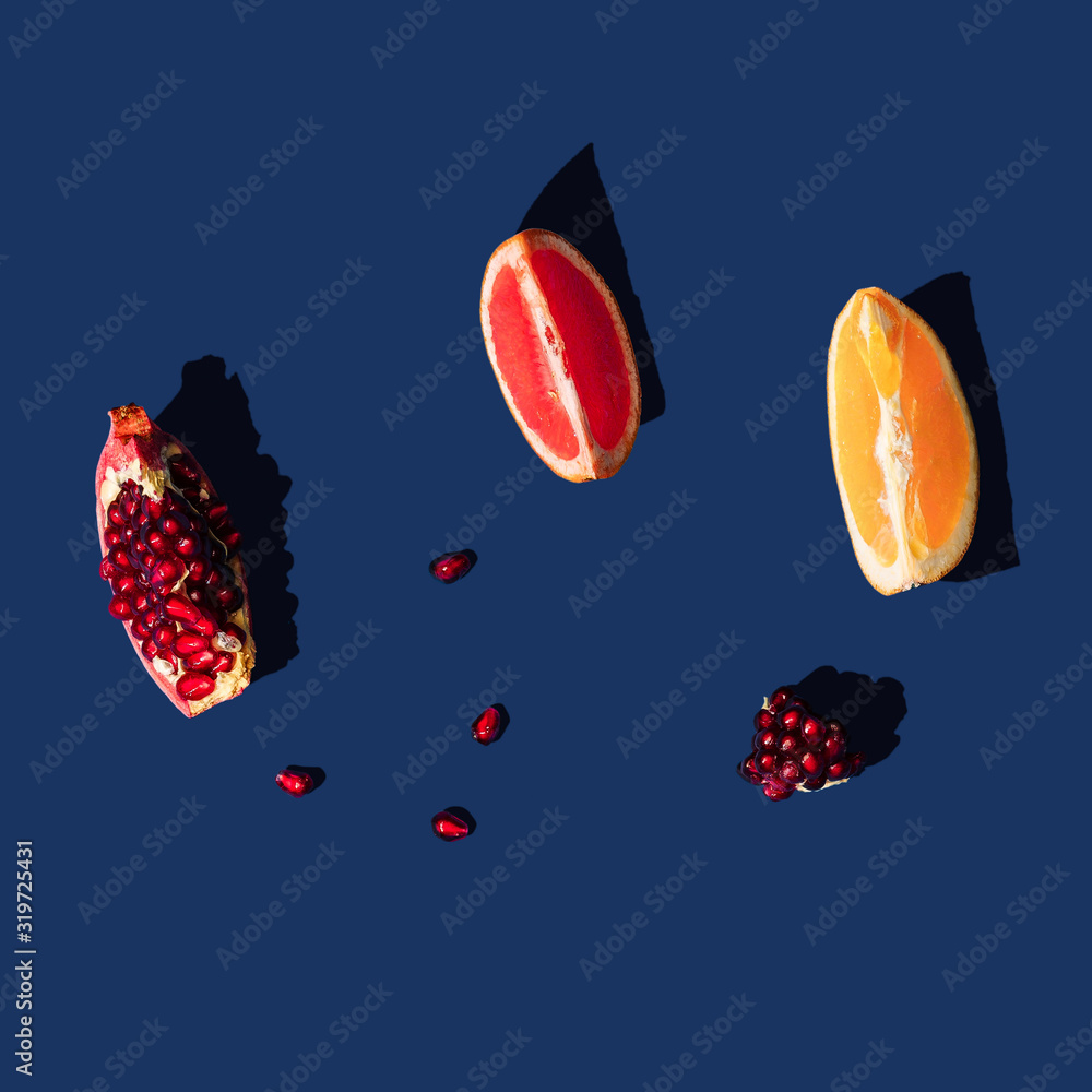 Wall mural flat lay layout with summer citrus fruit on blue background. minimal concept with sharp shadows. tre