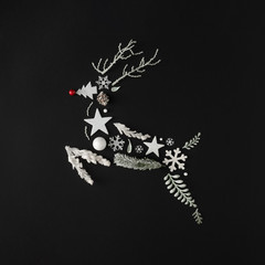 Winter natural leaves, branches, snowflakes and stars in shape of Christmas reindeer. Holiday...