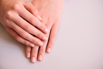 Fototapeta premium neat manicure hands on a neutral background