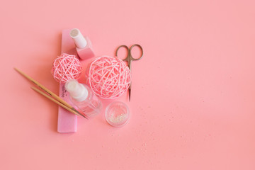 accessories for manicure in a beauty salon on a pink background