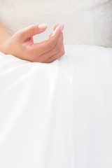 Wedding bride hand with luxury bright dress at marriage ceremony. Elegant stylish engagement wife with nails polished. Woman is waiting for ring and vow. Romantic love scene with large white copyspace