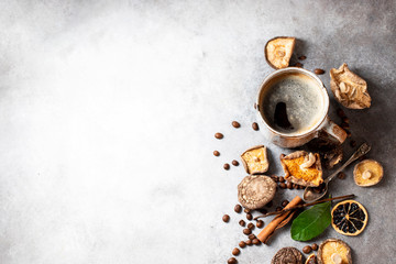 Mushroom coffee, a ceramic cup, mushrooms and coffee beans on stone concrete background. New Superfood Trend.