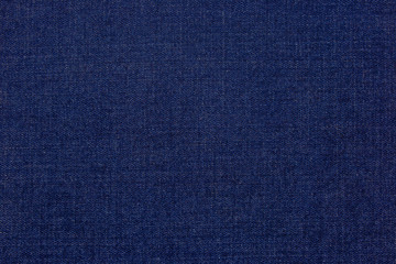 Stylish blue denim background from fabric. The workpiece of the designer.