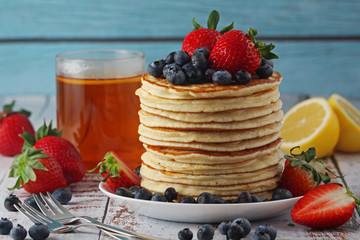 A stack if home-made pancakes with berry