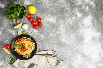 Plate with tasty pasta bolognese on grey background