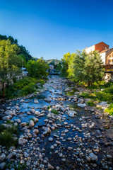 Fototapeta na wymiar Bridge over la Volane river in Vals-les-Bains, a spa town in the Ardèche departement in southern France a day of summer