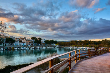 Fototapeta premium Ride in Porto Colom, Mallorca, Balearic Islands. Beautiful fishing port at sunset under a beautiful cloud sky.