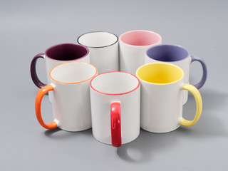 colored cups for sublimation in composition on a gray background