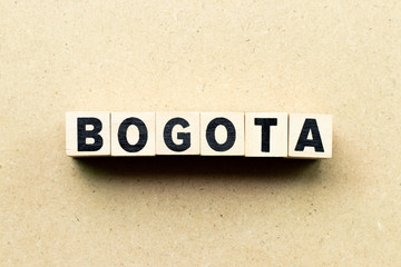 Letter block in word Bogota on wood background