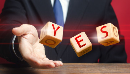 Cubes thrown by a man make up word YES. Agreement and acceptance, answer the question. Confirmation and approval. Important decision. Correct answer. Courage, irresistibility, zeal forwards, consent.