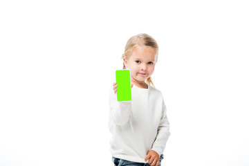 adorable kid showing smartphone with green screen, isolated on white