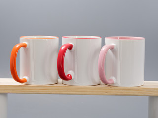 colored cups for sublimation in composition on a gray background