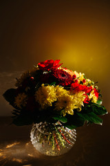 Colorful flowers in a vase. Isolated on yellow background.