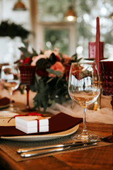 Beautiful, decorated table with flowers and red candles. Luxury Christmas evening or wedding party decoration.