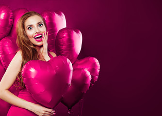 Valentine's day concept card background. Happy excited woman having fun and holding heart balloons