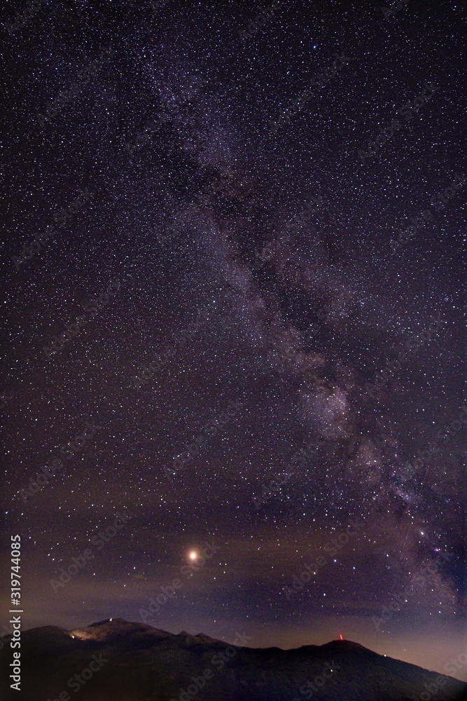 Poster Vertical picture of rocks under a starry sky during the night