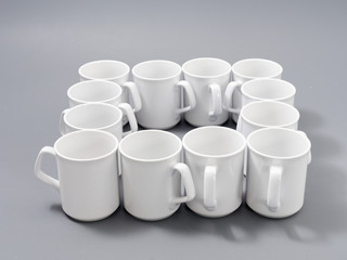 white cups for sublimation in composition on a gray background