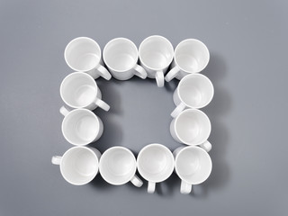 white cups for sublimation in composition on a gray background