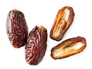 Two fruit dates and halves on a white background. The view from top