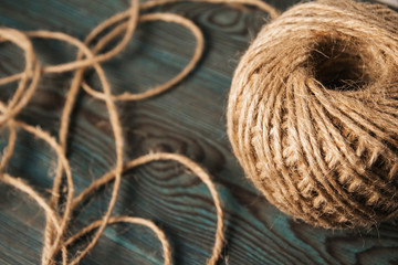 Reel of jute twine on a blue wooden background.