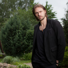 Young elegant handsome man posing outside.