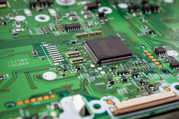 Green system board with microchips and transistors.