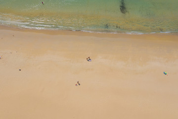 Aerial:Beautiful beach. PHUKET, THAILAND Patong beach. sandy beach and blue transparent water. Umbrella. Water scooter