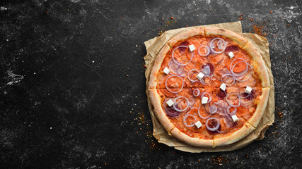 Homemade pizza with salami, feta cheese and onion. Top view. free space for your text.