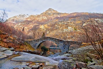Ancient stone bridge on the Fondo waterfall, in the alpine Chiusella Valley, Piedmont, Italy