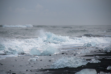 Ice chunks washed up on a black sand beach