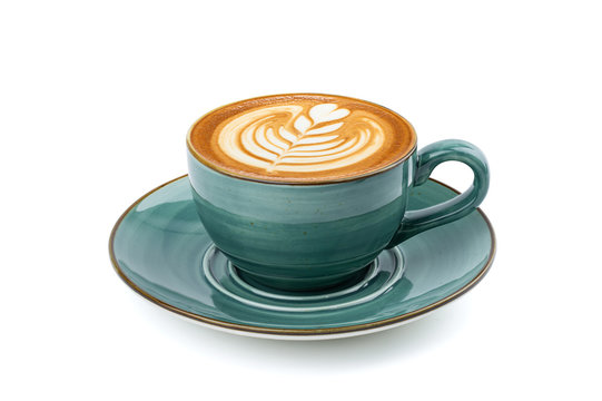 Side view of hot latte coffee with latte art in a vintage ceramic green cup and saucer isolated on white background with clipping path inside. Image stacking techniques.