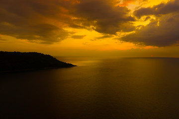 Fototapeta na wymiar Aerial view of sunset over the sea , Phuket, Thialand. Sunset of sun setting over ocean. Tranquil idyllic scene of a golden sunset over the sea with reflection.