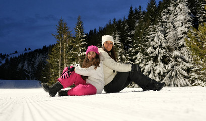 Mom and daughter having fun on winter vacation