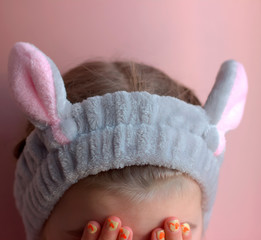 little beautiful girl wearing bunny ears headband. harry easter and easter hunt concept
