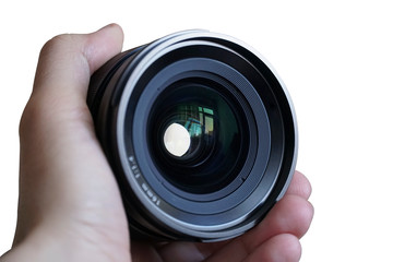 A 16mm prime lens on hand, isolated on white background