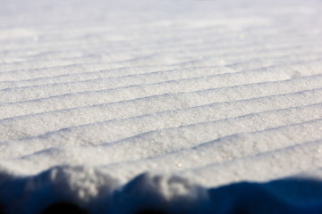 Slate roof covered with snow close-up. Wavy slate in the snow. Building geometric background. Slate and snow Lines. Winter background