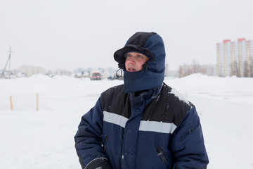 Fototapeta na wymiar Closeup portrait of a worker on the ice of a frozen river