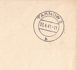 Fragment of postal envelope with postmark city Tarnow. Grey-beige background, stamp Poland 1941