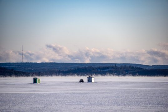 ice huts on frozen lake