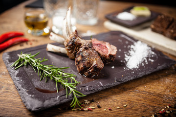 Grilled lamb chops served with a branch of rosemary