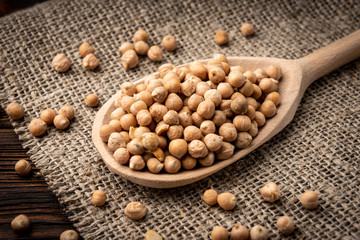 Chickpea on dark wooden background.