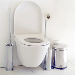 Closeup of toilet bowl and roll on toilet paper holder in hotel. Toilet paper roll in restroom....