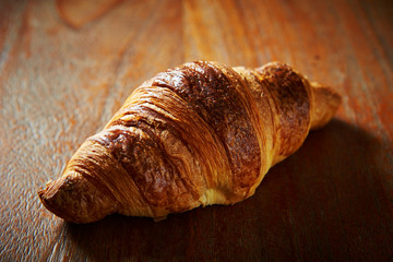 Croissant bread on wooden background 