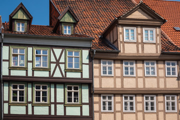 Fototapeta na wymiar Front view of the facade of a traditional half-timbered house. An example of Fachwerk in the medieval city of Quedlinburg, Saxony-Anhalt, Germany. 