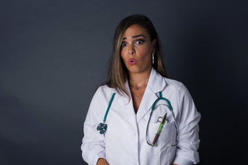 Brunette doctor woman expressing disgust, unwillingness, dislike, disregard having tensive look frowning face. Cauasian woman with pleasant appearance looking indignant digusting something